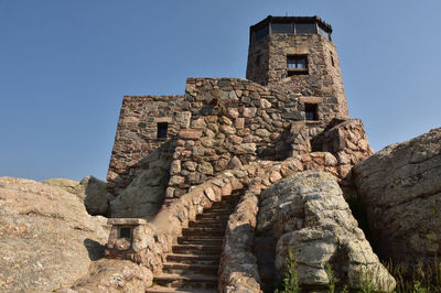 Stone castle with a tower in the black hills of south dakota.
