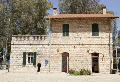 Rear view of man standing against building