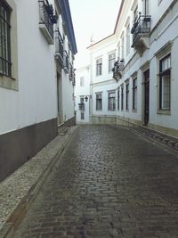 Cobblestone street amidst buildings