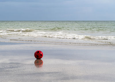 Quiet place,  red ball on the beach