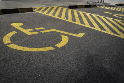 High angle view of arrow sign on road