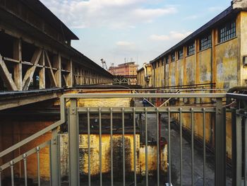 Train on bridge in city against sky