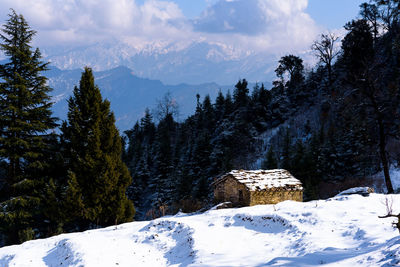 Scenic view of snow covered mountains against sky