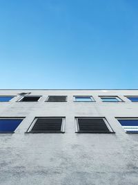 Low angle view of building against clear blue sky