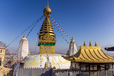 Low angle view of traditional building against clear blue sky