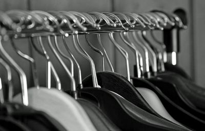 Close-up of empty coathangers on rack