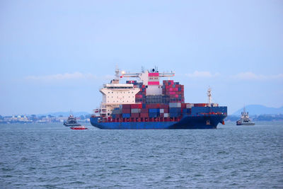 Ship sailing on sea against sky