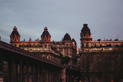 Buildings in city against clear sky