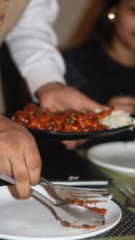 Cropped hand of man holding food