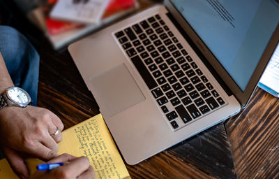 High angle view of man using laptop on table