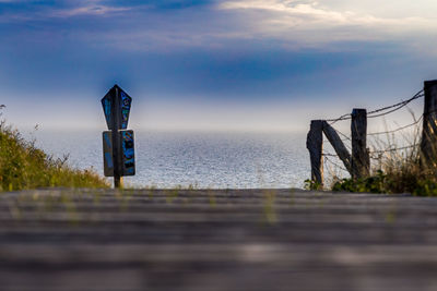 Bridge over sea against sky during sunset