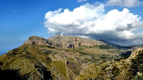 Panoramic view of rocky landscape against cloudy sky