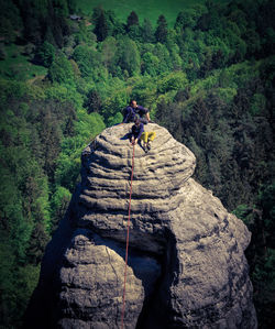 Men sitting on rock formation 