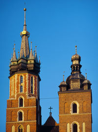 Low angle view of bell tower against clear blue sky