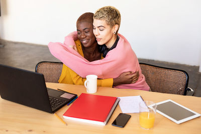 Lesbian couple embracing at office