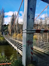 Close-up of bridge by tree against sky