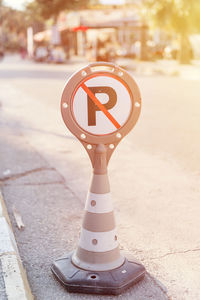 Cone warning about a parking ban of automobile and cars. traffic safety sign on city street road