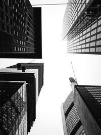 Directly below shot of buildings in city against sky