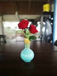 Close-up of roses in a vase on table