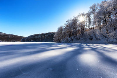 Scenic view of snowcapped mountains against clear blue sky