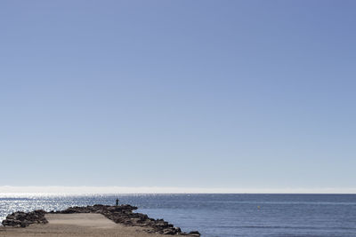Scenic view of sea against clear blue sky