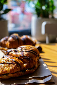 Fresh and tasty croissants with chocolate butter and banana on crumpled paper. breakfast at cafe. 