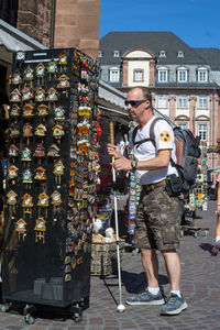 Full length of man standing against buildings in city