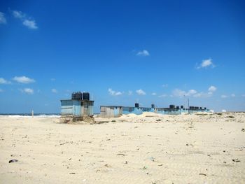 Scenic view of beach against blue sky