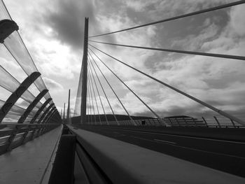 Low angle view of suspension bridge against sky