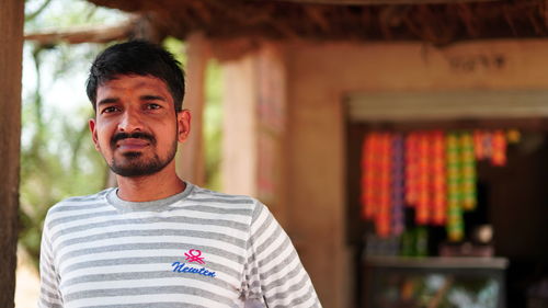Portrait of young man standing outdoors