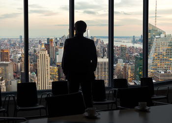 Rear view of man looking at city