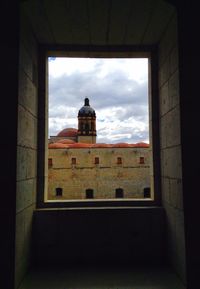 Low angle view of building against cloudy sky