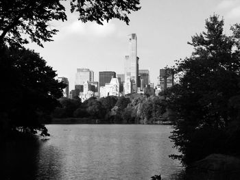 Lake and buildings against sky