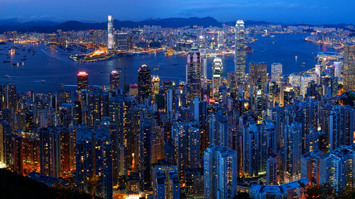 High angle view of city lit up at night