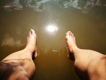 Low section of man legs in lake