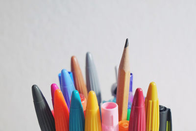 Close-up of colored pencils against white background