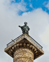 Low angle view of statue  against sky