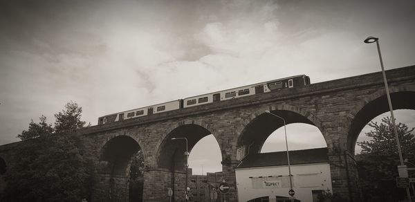 Low angle view of arch bridge against sky