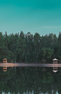 Reflection of trees in lake against sky