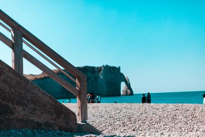 Scenic view of beach against clear blue sky