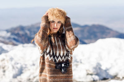 Portrait of woman standing in snow