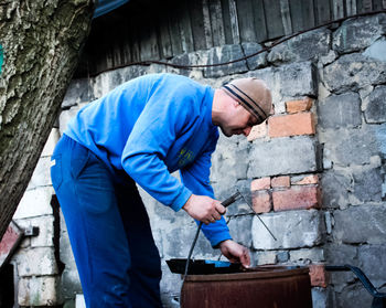 Full length of man standing on bed