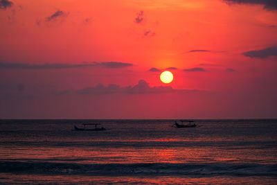 Scenic view of sea against orange sky