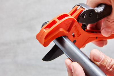 Cropped hand of man holding equipment