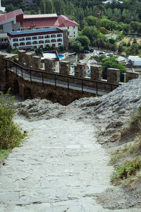 Houses by street against buildings in city
