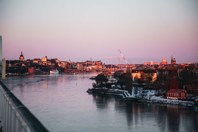 River with buildings in background at sunset