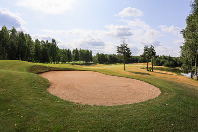 Panoramic view of golf course against sky