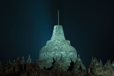 Low angle view of temple building against clear sky at night