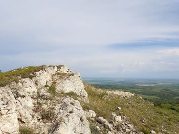 Rocks by mountain against sky