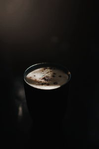 Close-up of coffee cup against black background